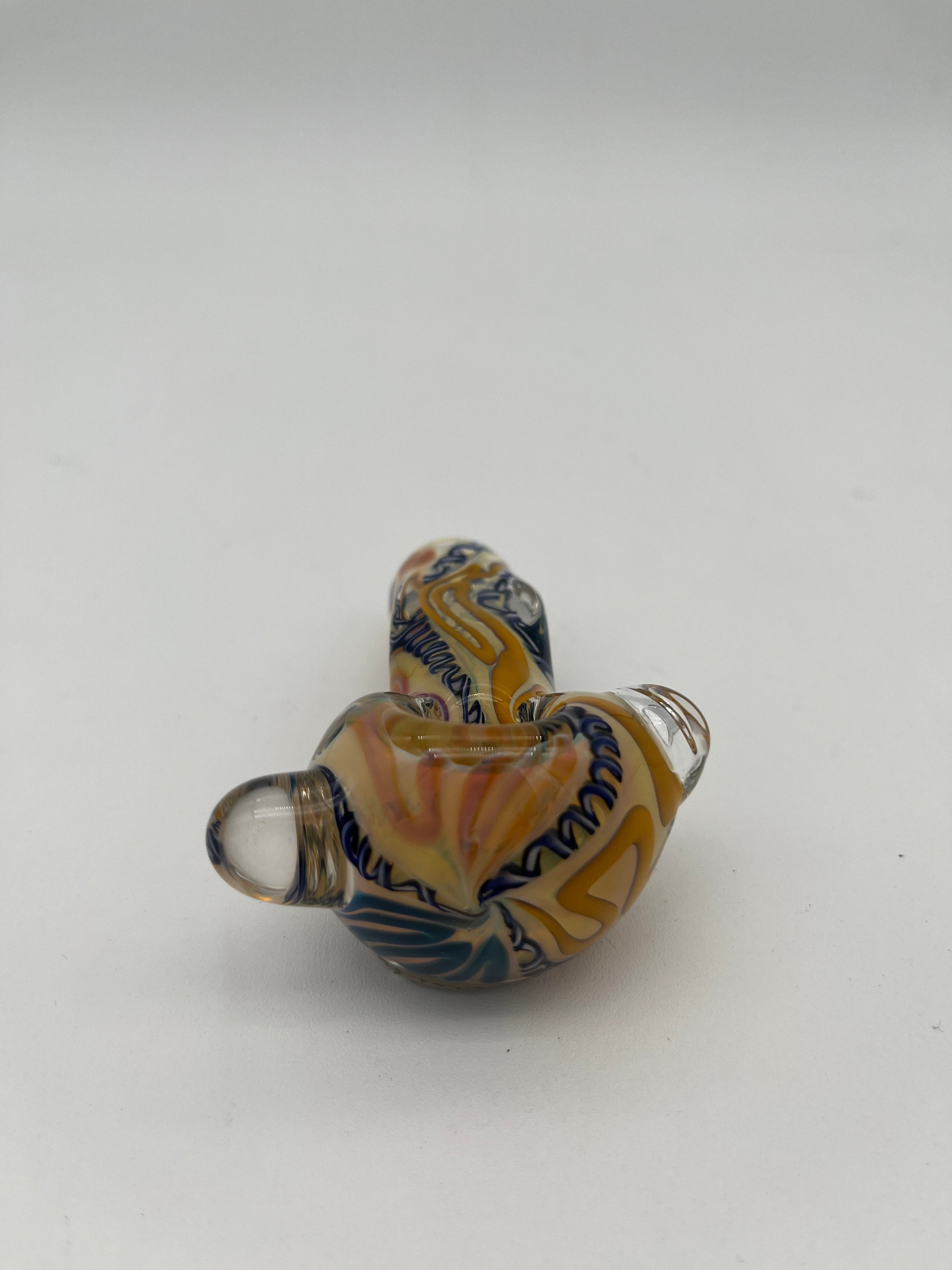 Blue and yellow inside out spiral glass hand pipe made by Nelson Glassworks on a white background. 