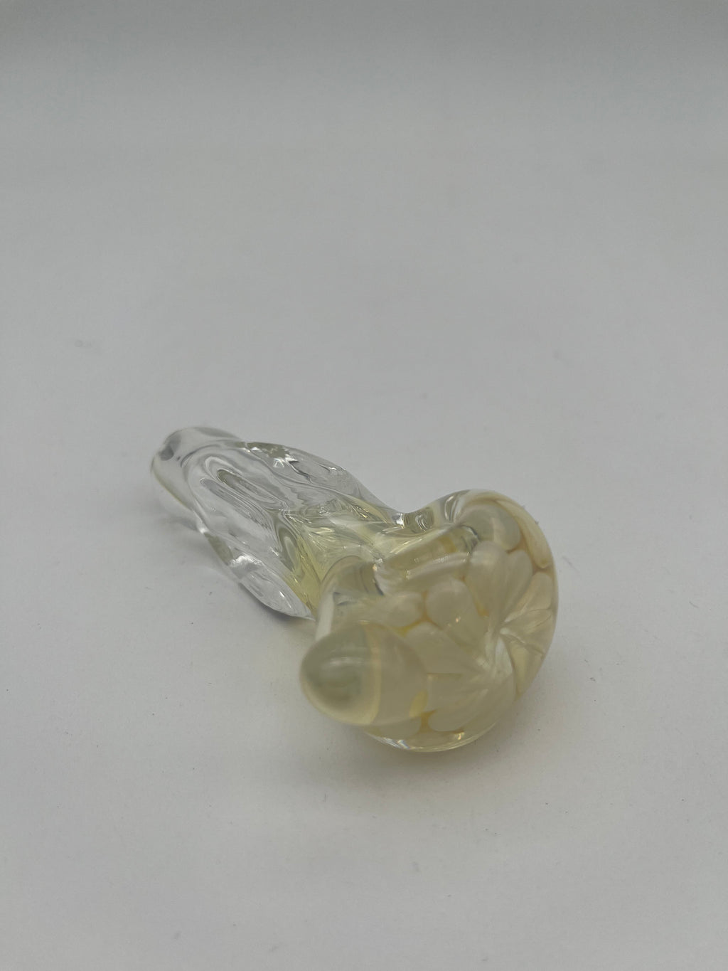 Clear and white floral looking glass pipe made by Nelson Glassworks on a white background.